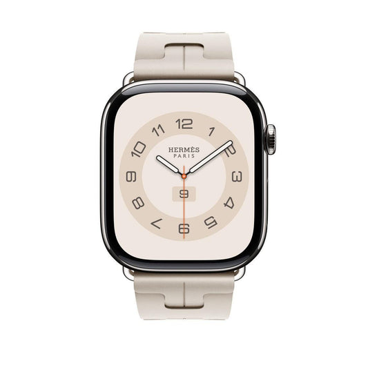 Polished stainless steel Apple Watch Hermès with light beige sport band and cream face.